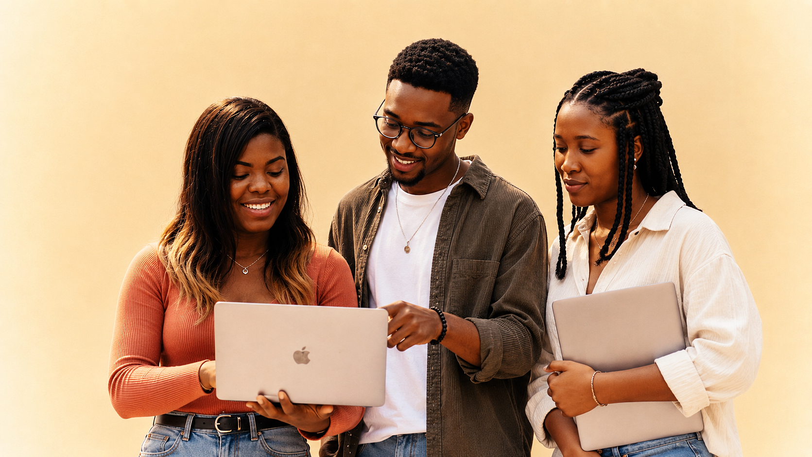 Three African builders looking at a laptop together